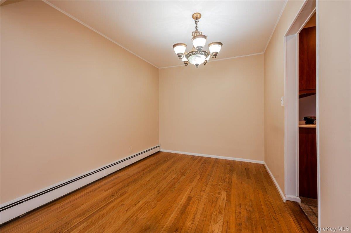 1674 Kroll Road East Meadow, NY 11554 - Photo 6 of 25 a view of a room with wooden floor and a chandelier