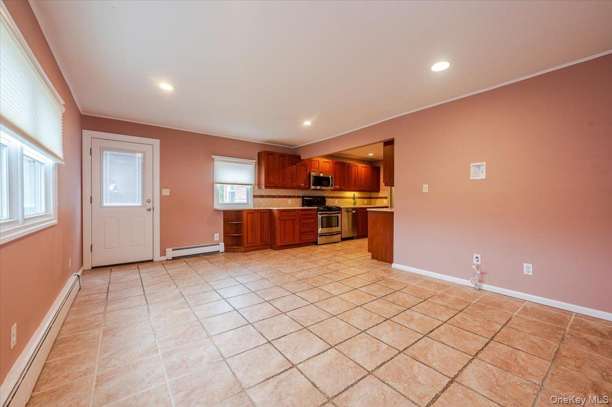 1674 Kroll Road East Meadow, NY 11554 - Photo 9 of 25 an empty room with kitchen appliances and windows