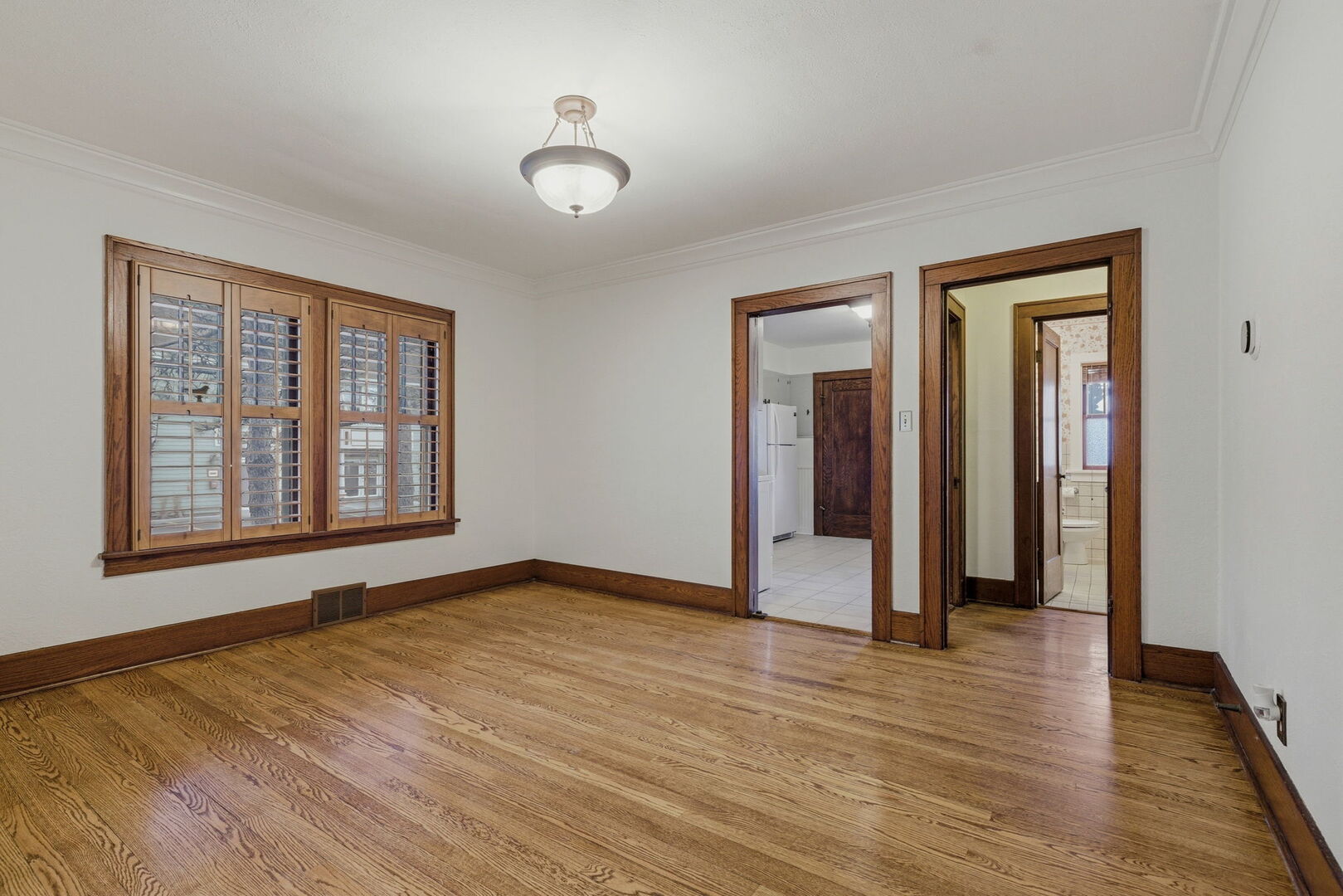 111 Oak Street Frankfort, IL 60423 - Photo 8 of 36 a view of an empty room with wooden floor and a window