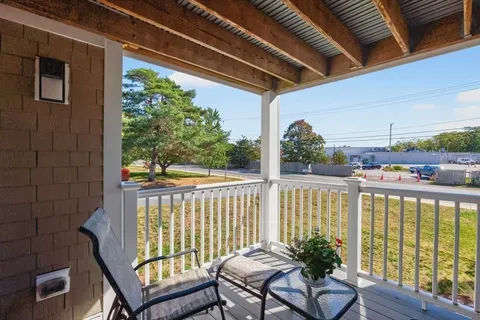 a view of a balcony with furniture