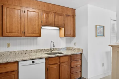 a kitchen with stainless steel appliances granite countertop a sink and cabinets