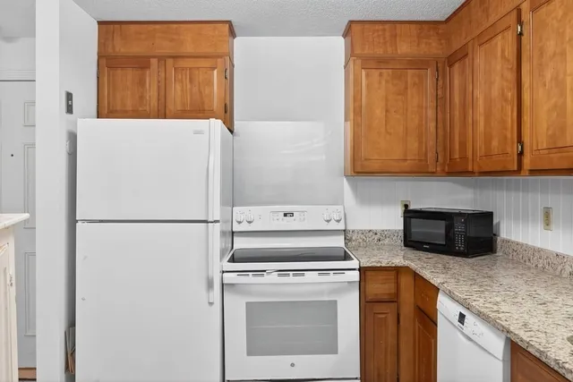 a kitchen with a refrigerator sink stove and microwave