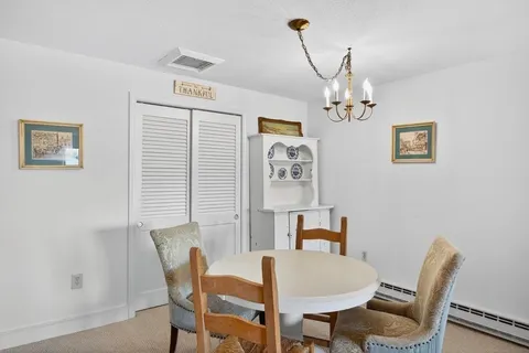 a view of a dining room with furniture and chandelier