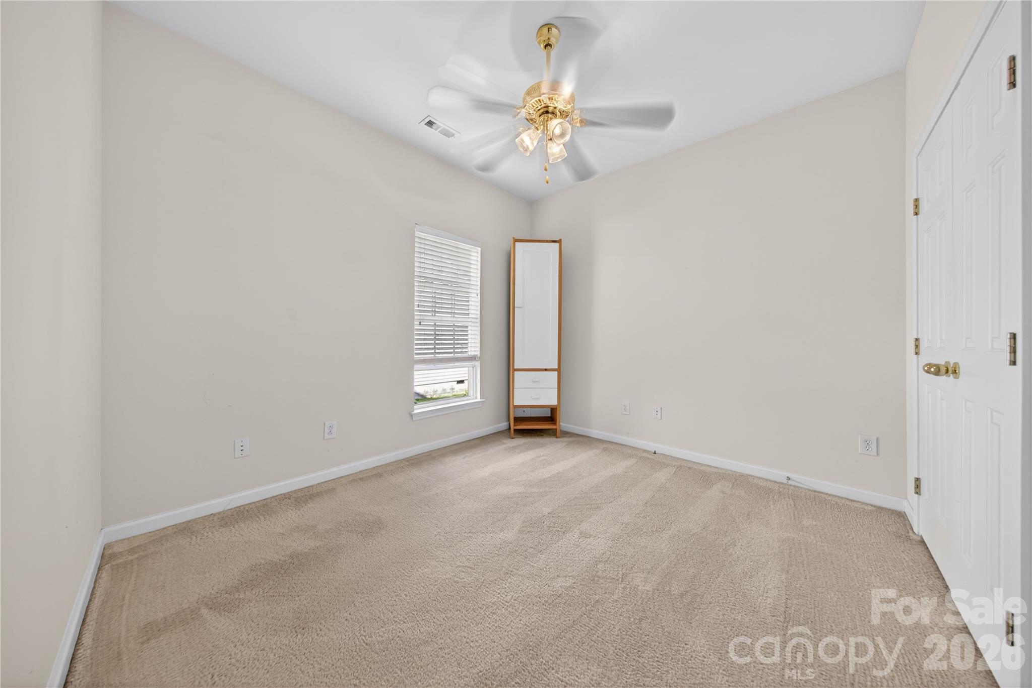 533 Fair Oaks Drive Fort Mill, SC 29708 - Photo 24 of 33 an empty room with a chandelier fan and windows