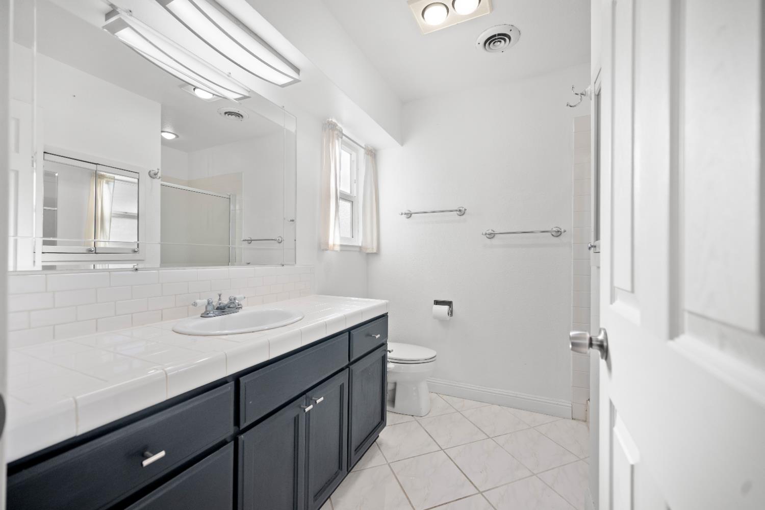 120 Eula Drive Modesto, CA 95354 - Photo 12 of 22 a bathroom with a sink a toilet a mirror and vanity
