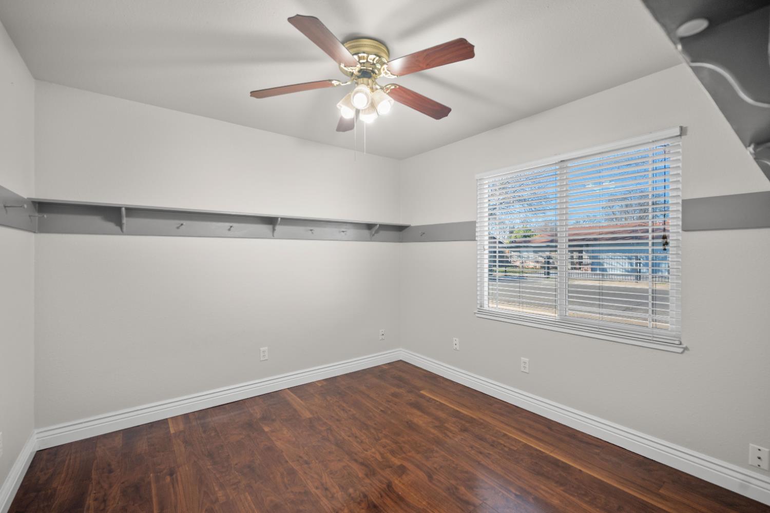 120 Eula Drive Modesto, CA 95354 - Photo 14 of 22 a view of an empty room with a window and wooden floor