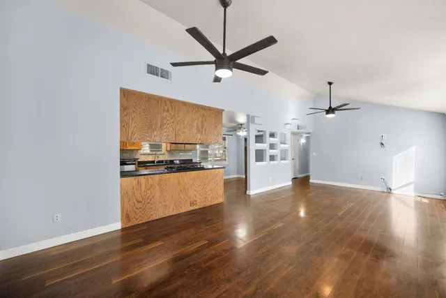 a view of a kitchen with a sink and a refrigerator