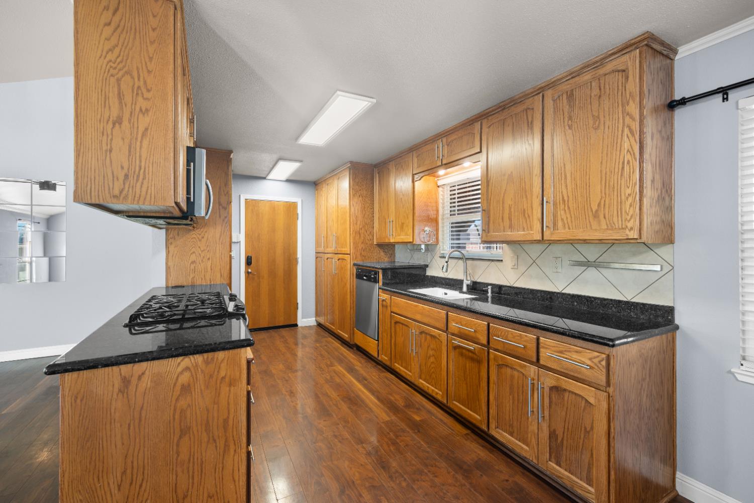 120 Eula Drive Modesto, CA 95354 - Photo 8 of 22 a kitchen with stainless steel appliances granite countertop a stove a sink and a refrigerator