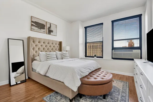 a bedroom with a bed and a large window