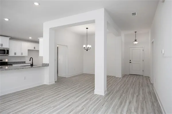 a view of a kitchen with wooden floor and a sink