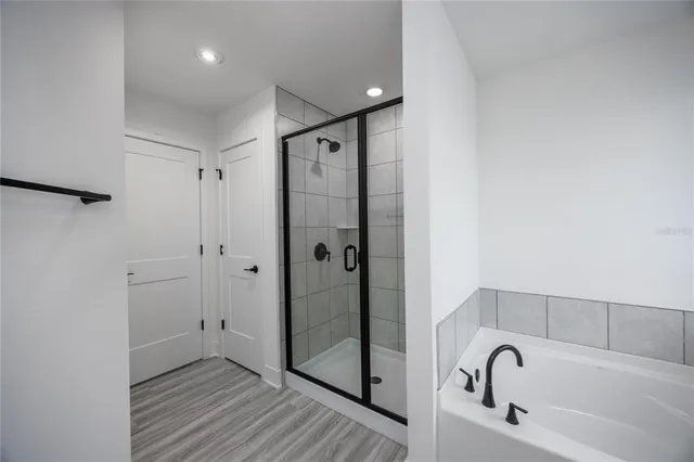 a bathroom with a bathtub and a shower