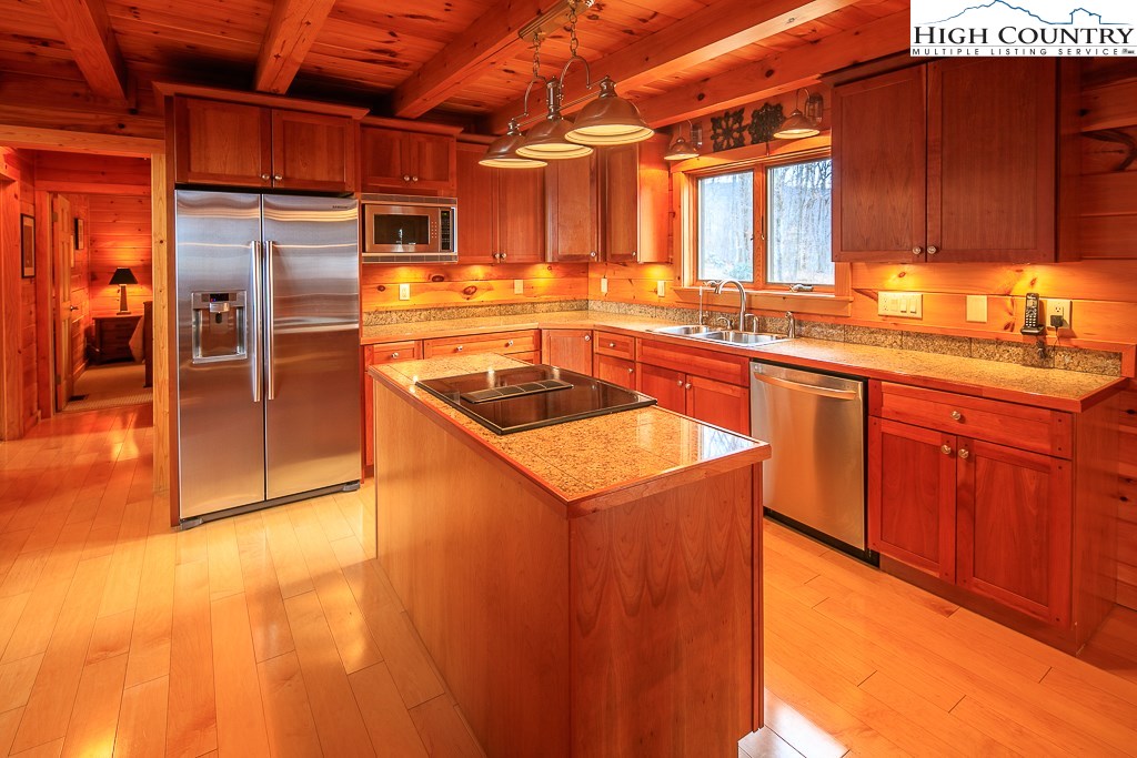 204 Pinnacle Ridge Road Beech Mountain, NC 28604 - Photo 18 of 50 a kitchen with stainless steel appliances granite countertop a sink and a refrigerator