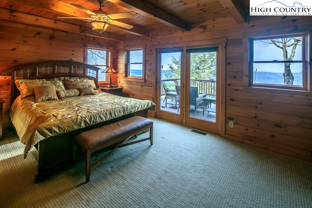 204 Pinnacle Ridge Road Beech Mountain, NC 28604 - Photo 23 of 50 a spacious bedroom with a bed and a dresser next to a window