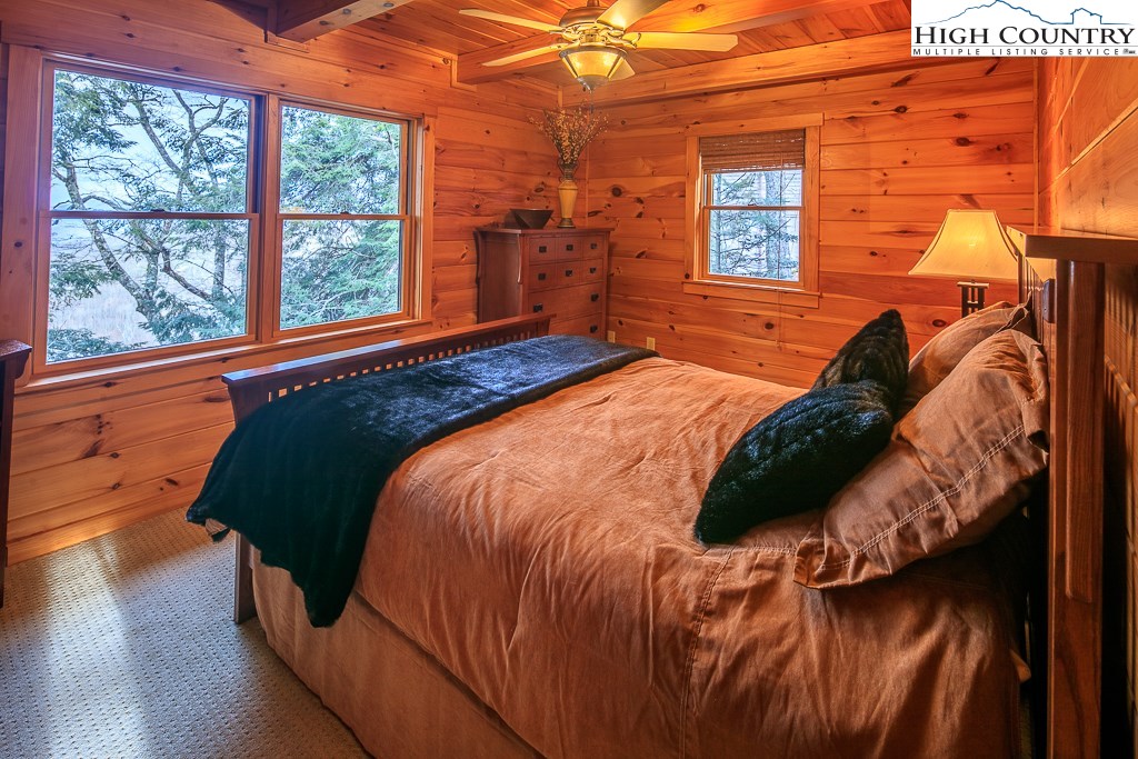 204 Pinnacle Ridge Road Beech Mountain, NC 28604 - Photo 26 of 50 a bed sitting in a bedroom next to a window