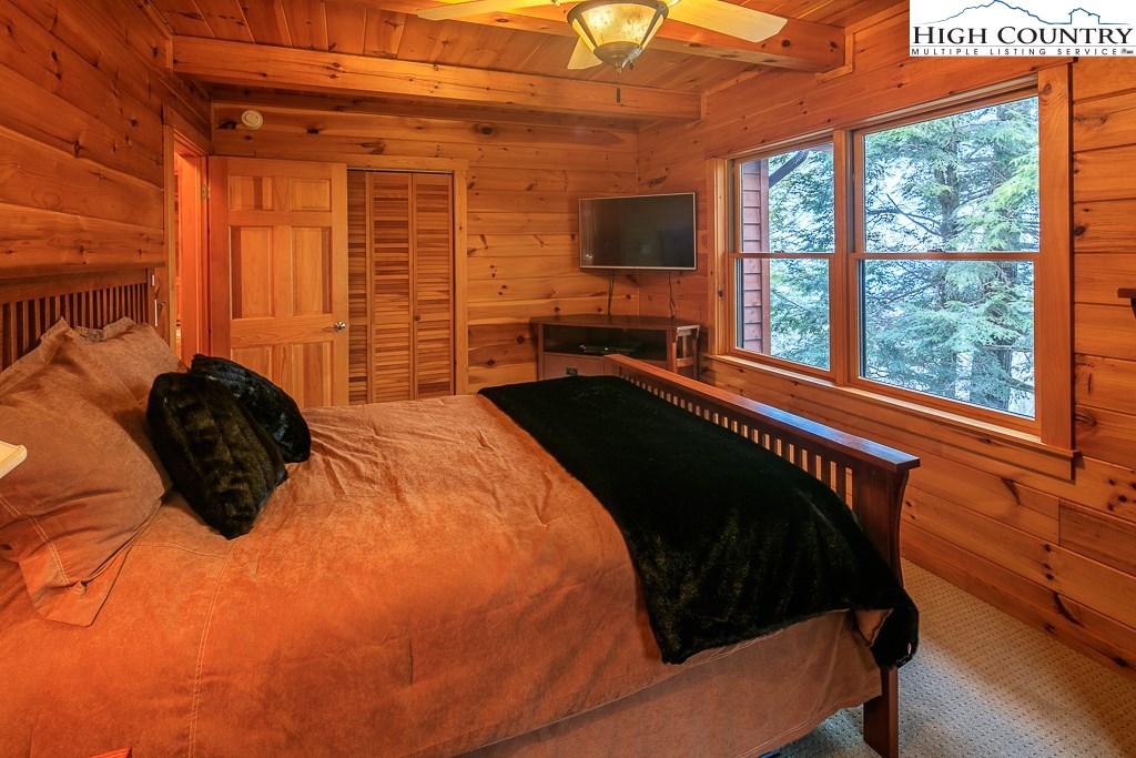 204 Pinnacle Ridge Road Beech Mountain, NC 28604 - Photo 27 of 50 a bed sitting in a bedroom next to a window