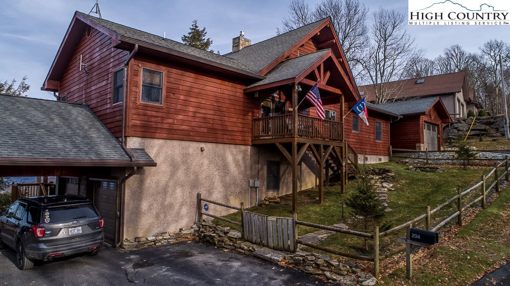 204 Pinnacle Ridge Road Beech Mountain, NC 28604 - Photo 47 of 50 a view of a house with a small yard and wooden fence
