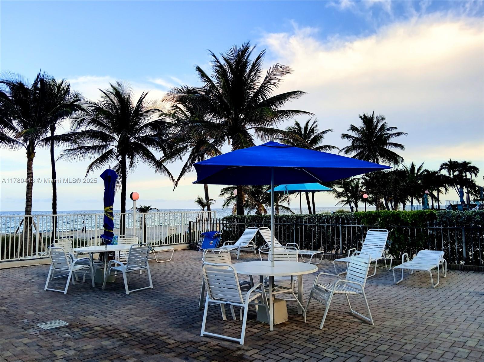 1000 South Ocean Boulevard, Unit 10E Pompano Beach, FL 33062 - Photo 13 of 64 a view of a table and chairs under an umbrella in patio