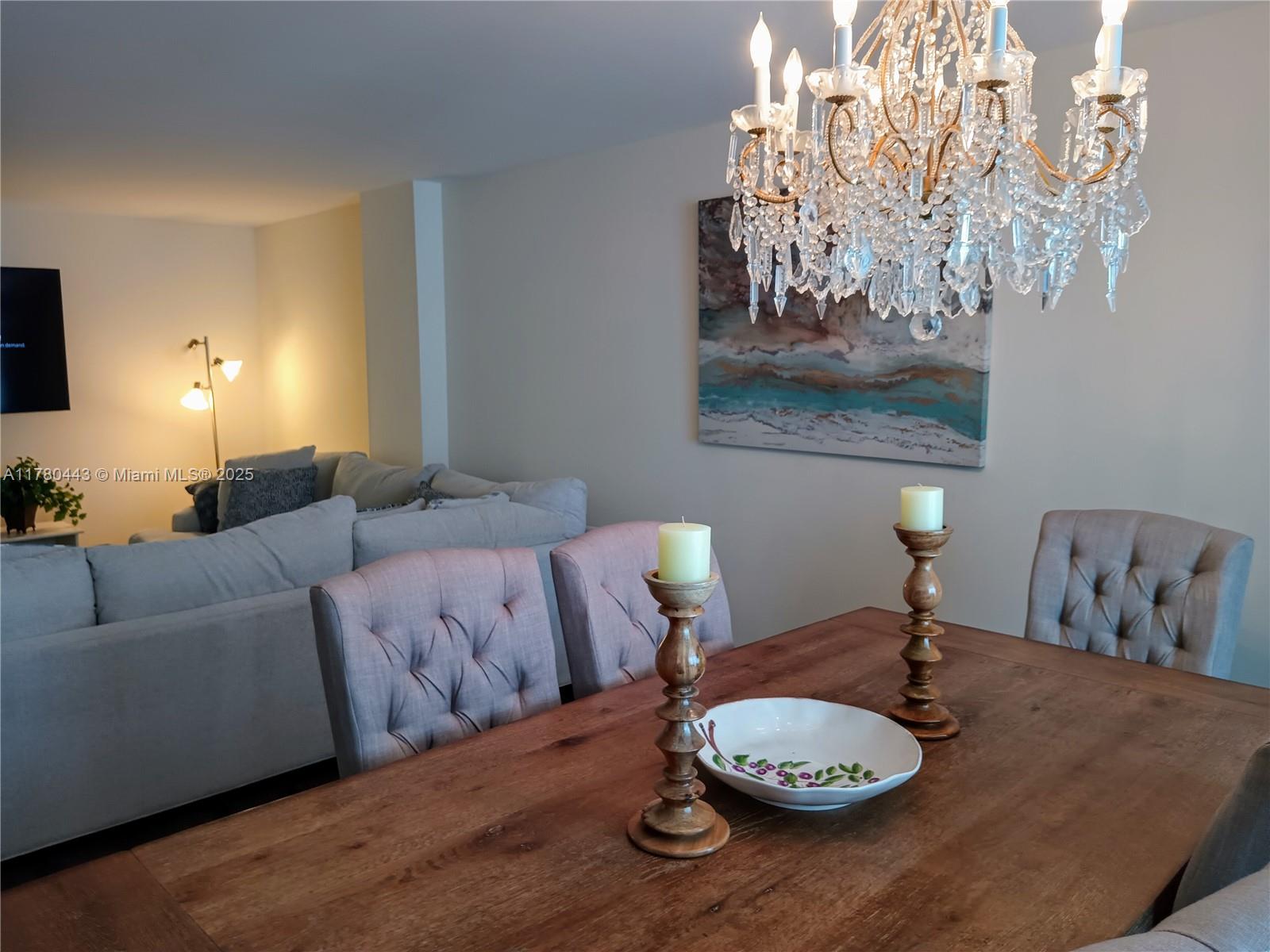 1000 South Ocean Boulevard, Unit 10E Pompano Beach, FL 33062 - Photo 26 of 64 a living room with furniture and a chandelier