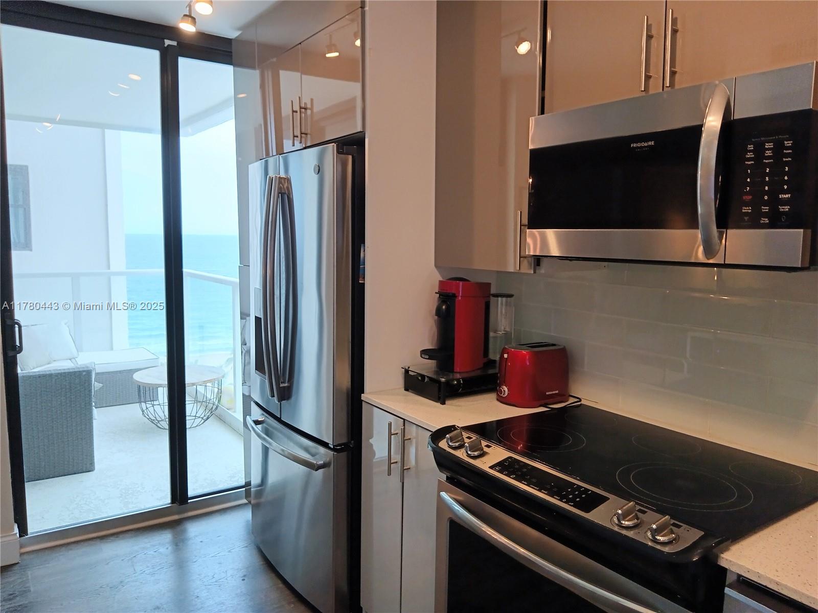 1000 South Ocean Boulevard, Unit 10E Pompano Beach, FL 33062 - Photo 32 of 64 a metallic refrigerator freezer sitting in a kitchen