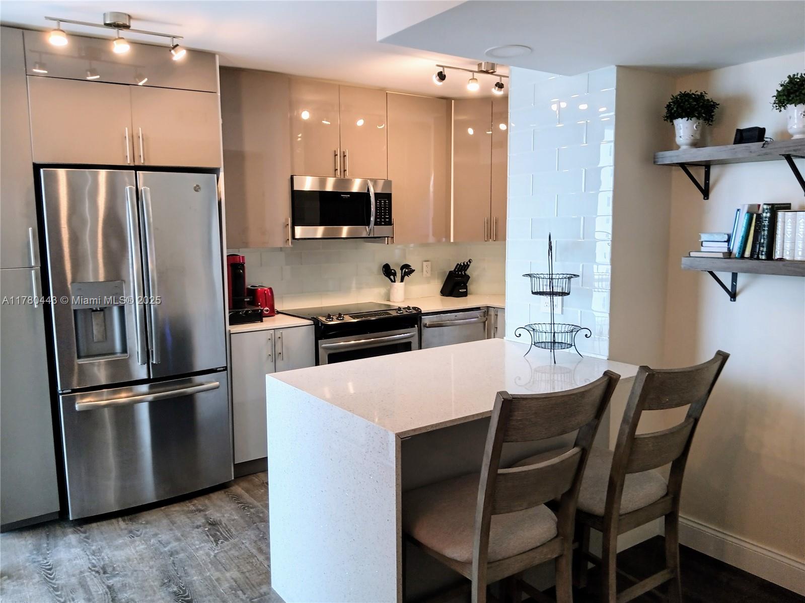 1000 South Ocean Boulevard, Unit 10E Pompano Beach, FL 33062 - Photo 34 of 64 a kitchen with stainless steel appliances a refrigerator stove microwave and cabinets
