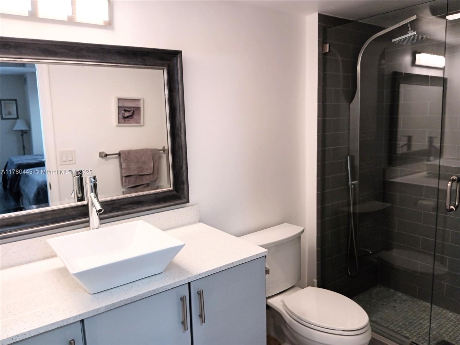 1000 South Ocean Boulevard, Unit 10E Pompano Beach, FL 33062 - Photo 50 of 64 a bathroom with a sink a toilet and shower