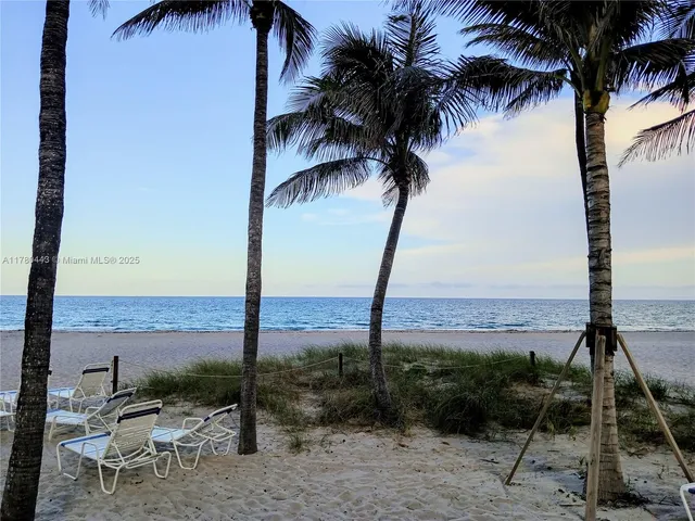 a view of a terrace with beach and ocean view
