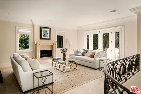 a living room with furniture a fireplace and a table
