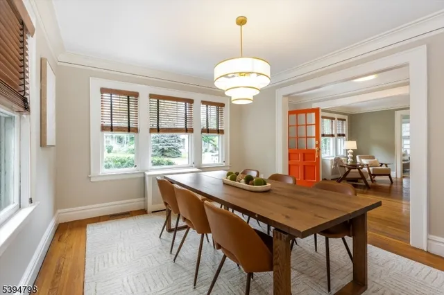a view of a dining room with furniture wooden floor and chandelier