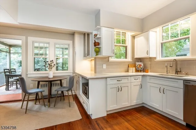 a kitchen with a table chairs sink and cabinets