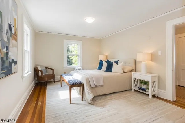 a bedroom with furniture and a wooden floor