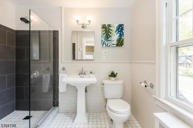a bathroom with a toilet sink and shower