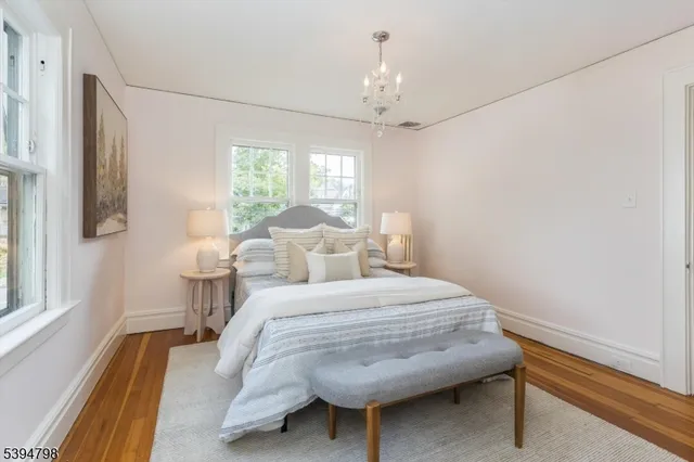 a bedroom with a bed and a chandelier