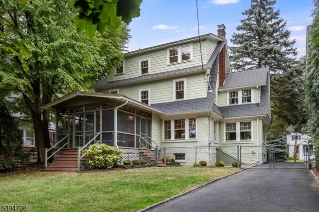 a front view of a house with a yard and porch