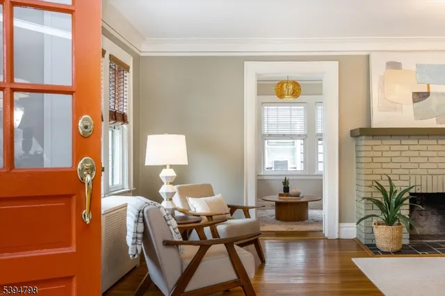 a living room with furniture a fireplace and wooden floor
