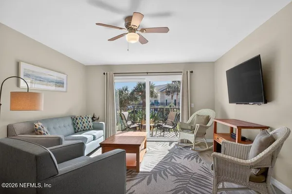 a living room with furniture and a flat screen tv