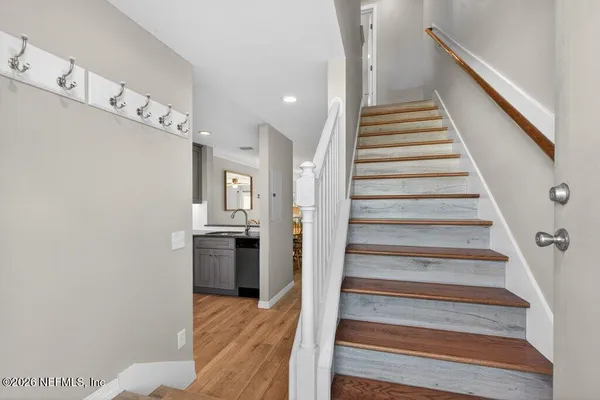 a view of entryway and hall with wooden floor