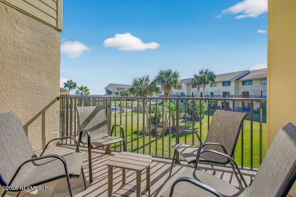 a view of a balcony with furniture