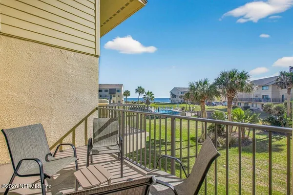 a view of a balcony with furniture