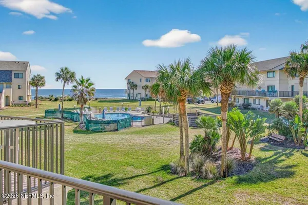 a view of a backyard with plants and swimming pool