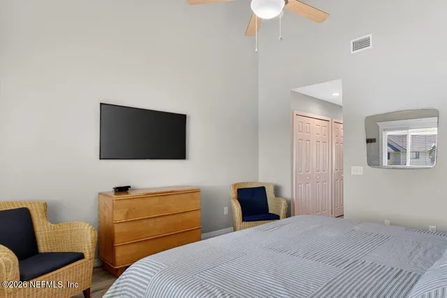 a bedroom with a bed and a television