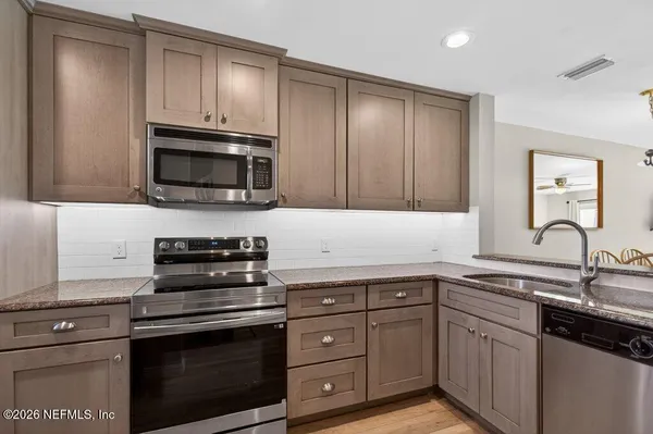 a kitchen with cabinets stainless steel appliances and wooden cabinets
