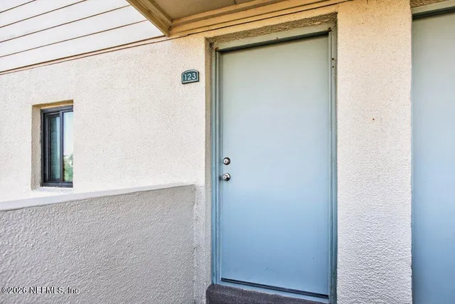 a front view of a building with a garden