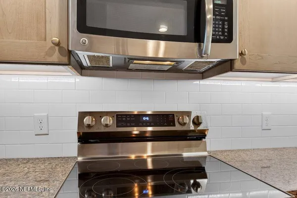 a stove top oven sitting inside of a kitchen