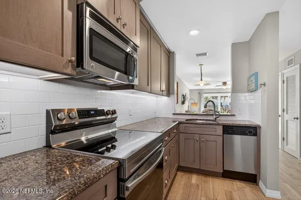a kitchen with a sink stove and microwave