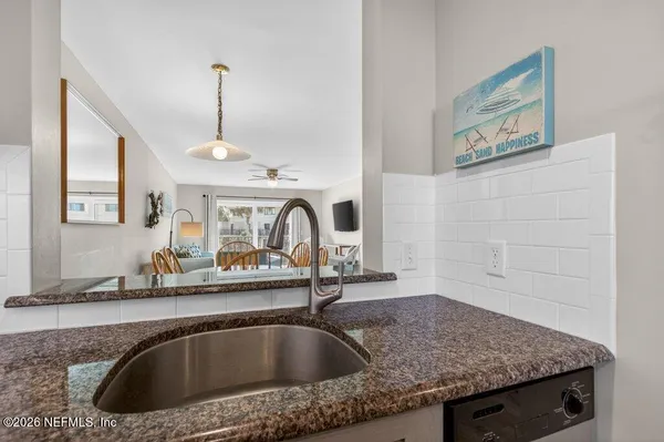 a kitchen with a sink a faucet and a counter top space