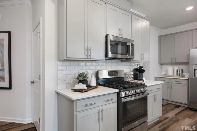 a kitchen with cabinets stainless steel appliances and a sink