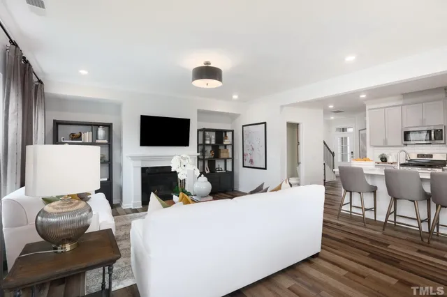 a living room with furniture a fireplace and a flat screen tv