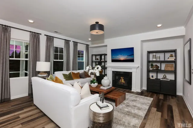 a living room with furniture a fireplace and a flat screen tv