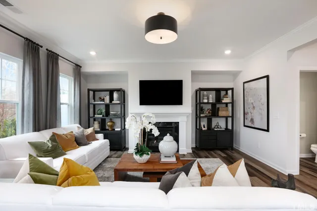 a living room with furniture fireplace and window
