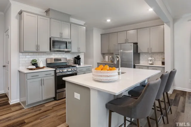 a kitchen with a stove a sink and a refrigerator
